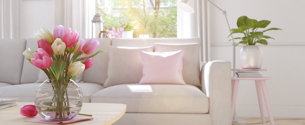 a living room with tulips in a vase on table