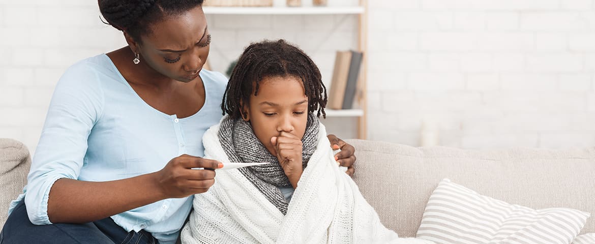 Mom taking child's temperature