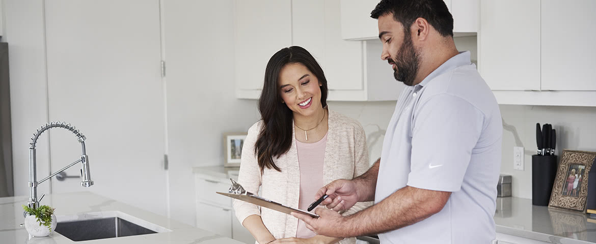 a Lennox dealer and a homeowner discussing things in her kitchen