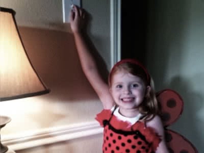 Little girl wearing a lady bug costume